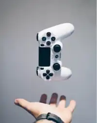 White console controller floating above a hand.