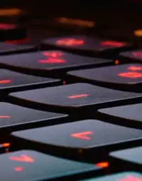 Laptop keyboard with red backlight.